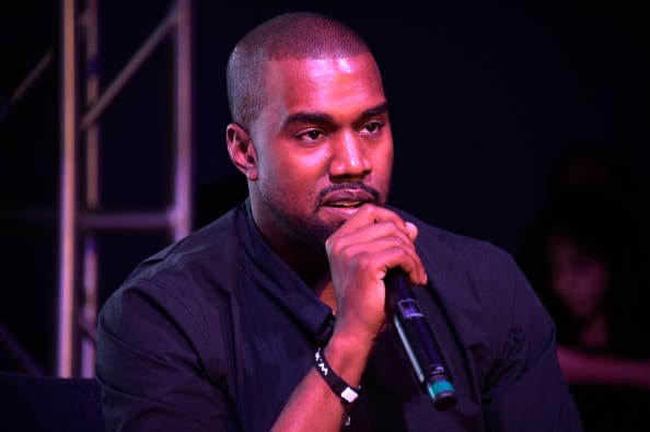 Kanye holding a mic at Surface Magazine's DesignDialogues