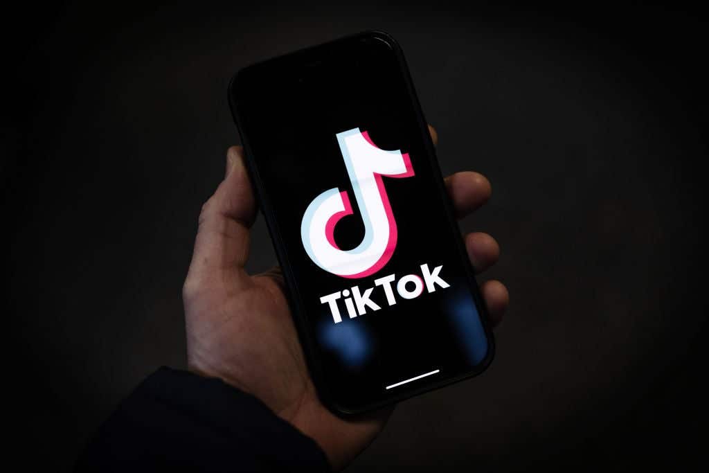 A person holding an iPhone with the TikTok app logo on it. Arizona Woman Got 'RIP TikTok' Tattoo Before It Got Restored