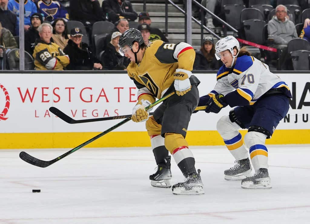 LAS VEGAS, NEVADA - JANUARY 20: Zach Whitecloud #2 of the Vegas Golden Knights skates with the puck against Oskar Sundqvist #70 of the St. Louis Blues in the first period of their game at T-Mobile Arena on January 20, 2025 in Las Vegas, Nevada. The Blues defeated the Golden Knights 5-4 in a shootout.